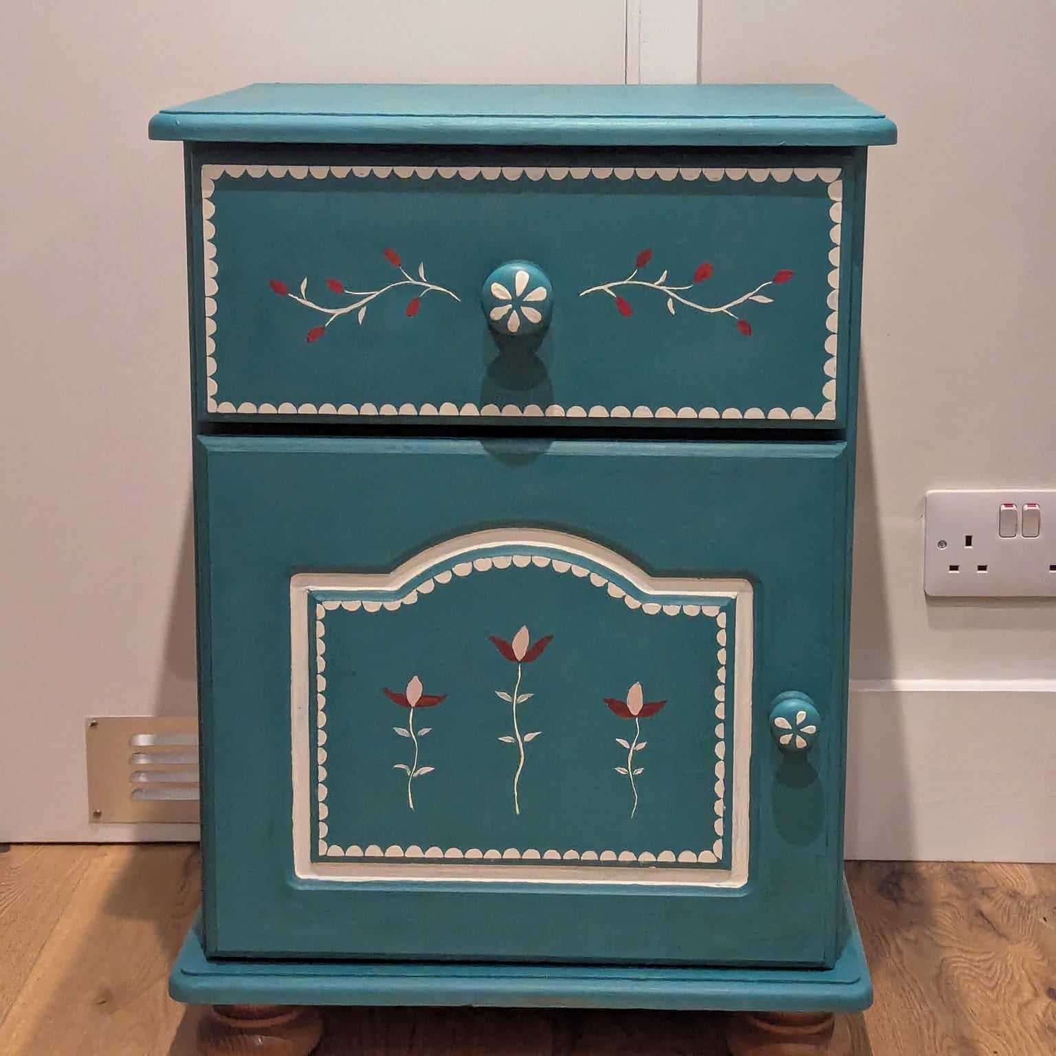 Teal Turquoise small cupboard/bedside table with folk art inspired design in red and white.